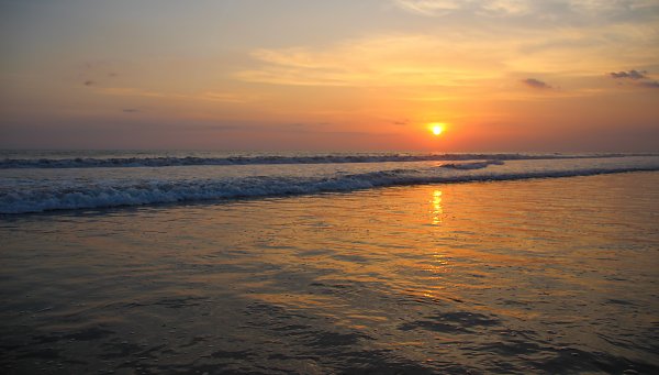 Untergehende Sonne am Meer Wandbild